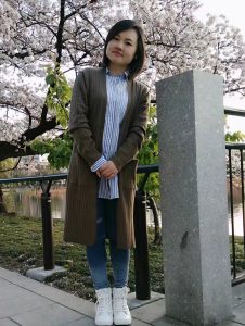 背後にきれいなサクラが咲いています。